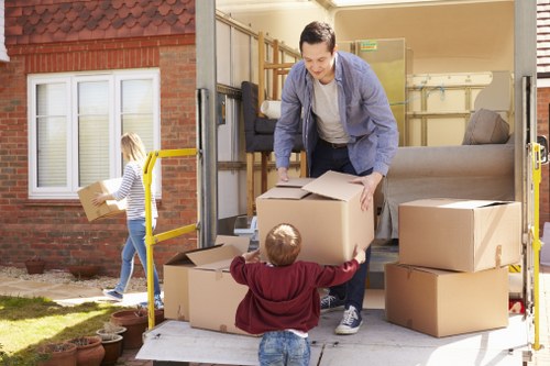Moving team reviewing safe handling procedures before loading a van