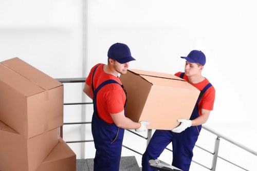 Careful loading of household furniture outside a Holloway flat
