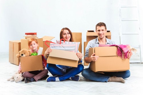 Worker loading furniture safely into a van with careful manual handling