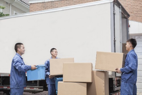Moving team handling furniture from a Victorian terrace in Holloway