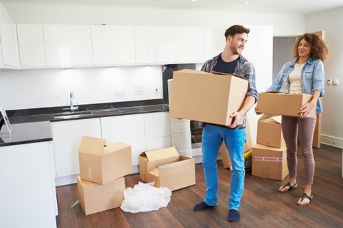 Packed boxes and furniture being loaded into a Holloway removal van